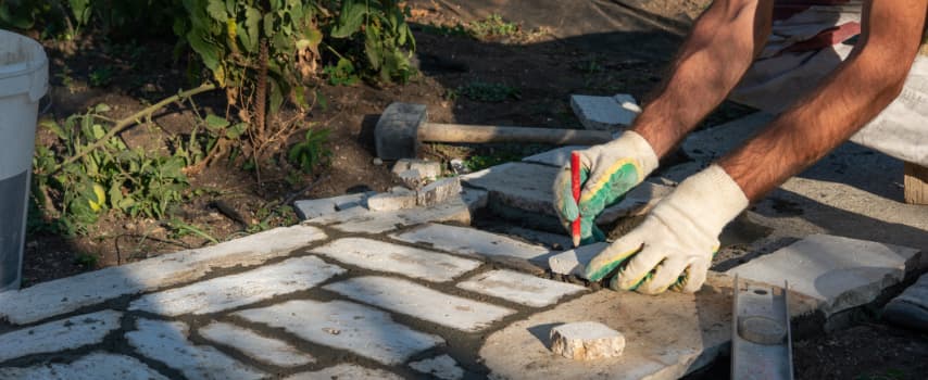 man laying paving