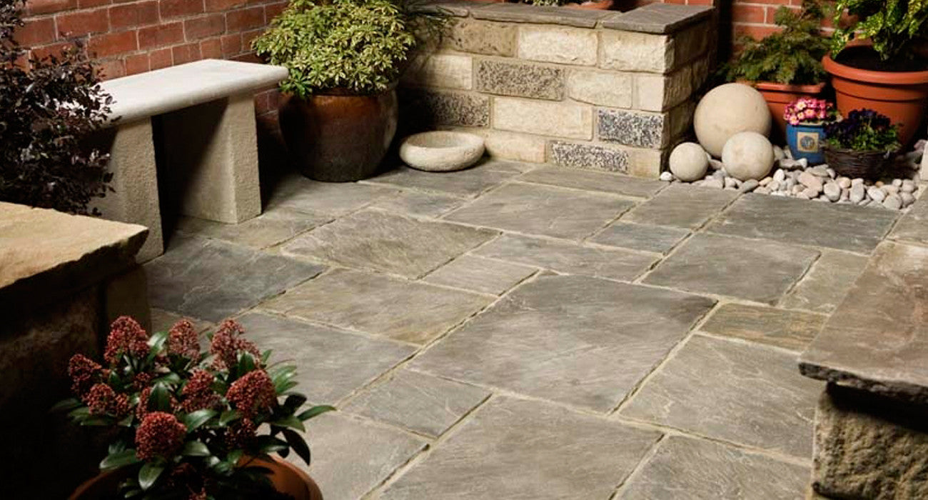 Premium paving slabs, including expertly finished sandstone, limestone, and porcelain, enhanced through specialist processes for a refined, high-end look.